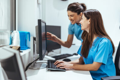 Professional Medical Staff Collaborating on Computer Screens in a Clinic
