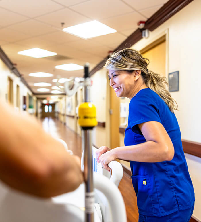 Nurses pushing a hospital bed with a patient down the hallway
